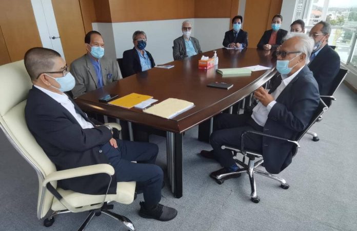 Minister in the Prime Minister's Department (Sabah and Sarawak Affairs) Datuk Seri Dr Maximus Ongkili being briefed on the Registered Trustees of Sabah Action Body Advocating Rights (SABAR) missions and visions by its Board of Trustees chairman Datuk Dr Johan Arriffin Abdul Samad (seated right) during the latter's call at the BHESS office at Wisma SEDIA in Kota Kinabalu, today, while other delegates look on.