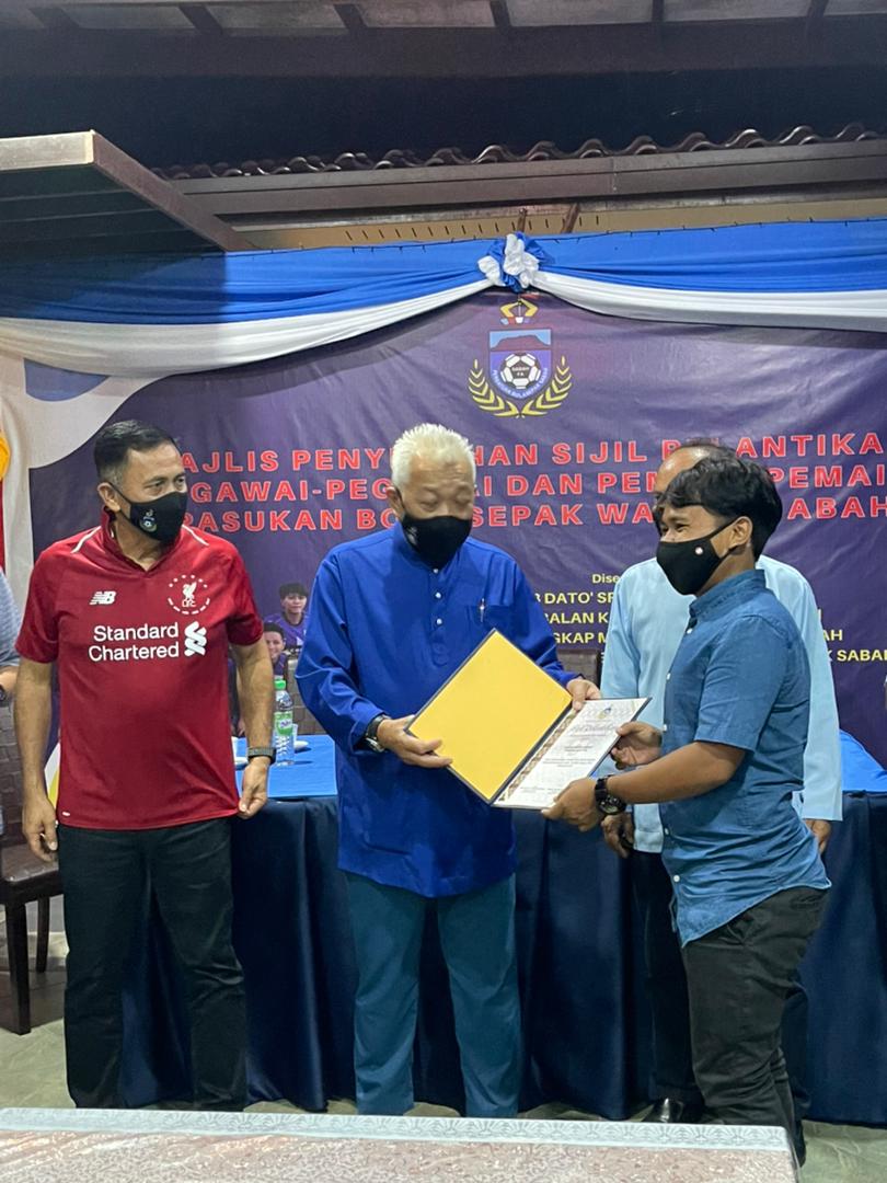 Bung diiringi oleh Yakub dan Jelani menyampaikan watikah perlantikan kepada salah seorang pemain bola sepak wanita Sabah yang terpilih di majlis tersebut.