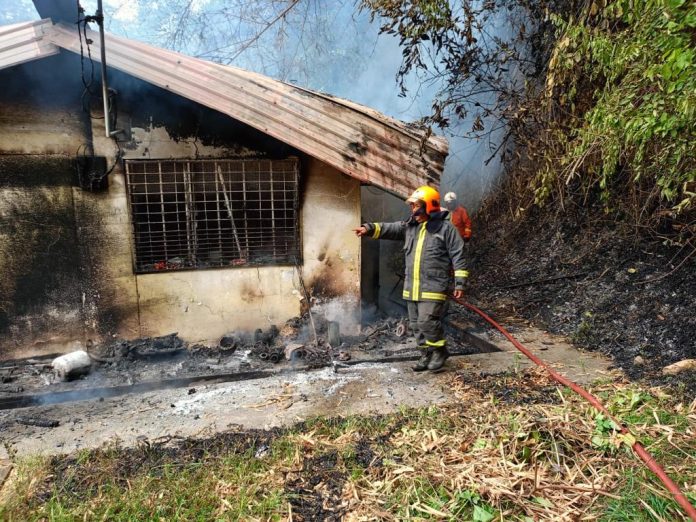 The condition of the house. Seen are firemen personnel involved in putting out the fire.